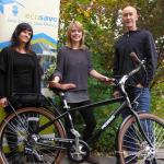 bike being raffled is shown with pedego owner and organization volunteers