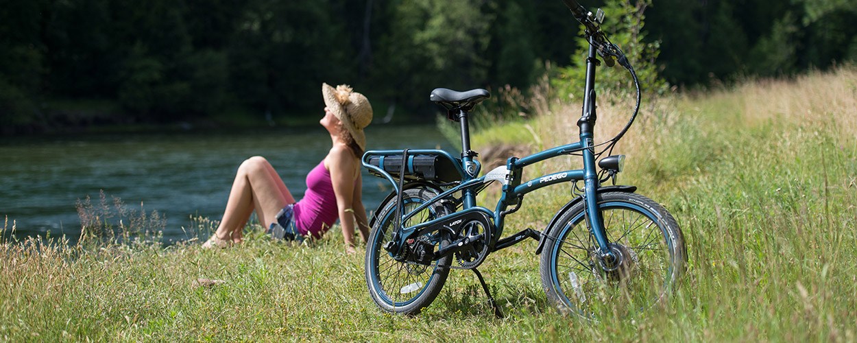 Woman enjoying electric folding bike in nature