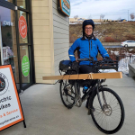 Dustin Anderson commutes to and from work on a Pedego City Commuter carrying cargo.