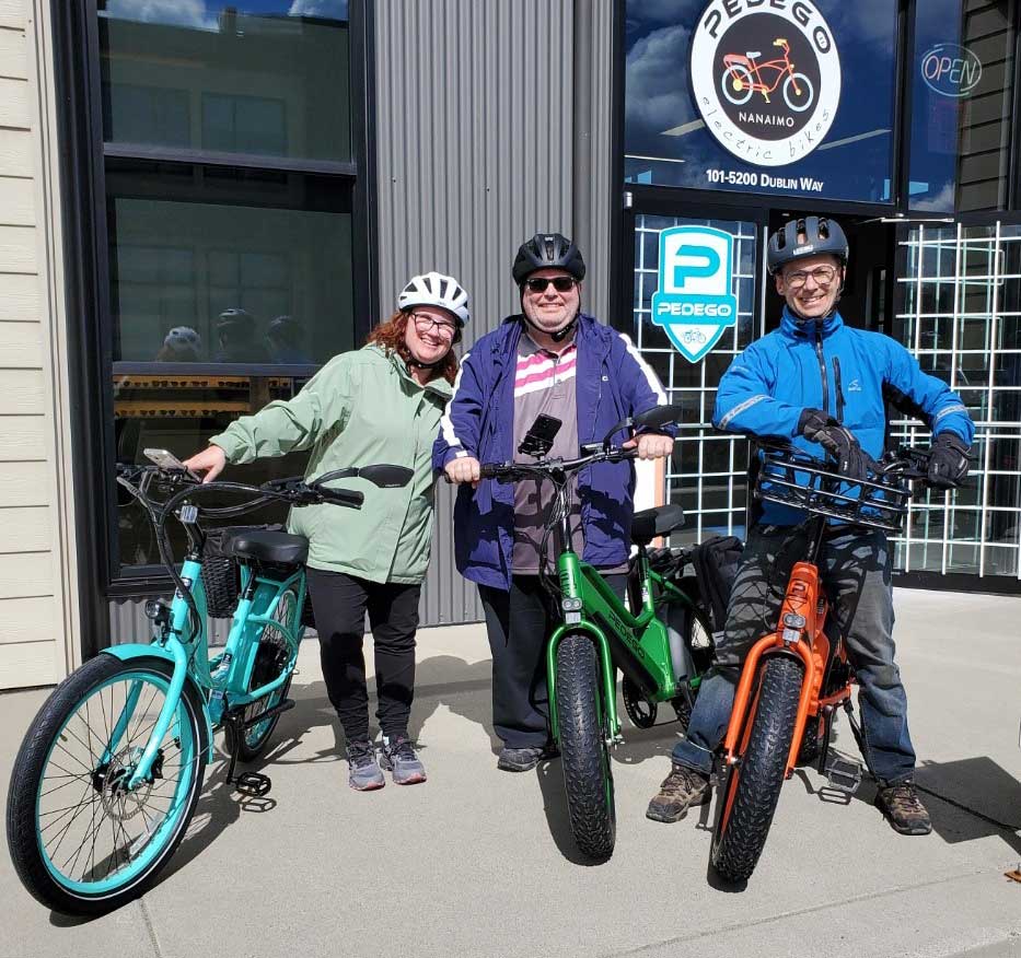 Pedego_Canada_Bikes_with_Names Three people with their pedego electric bikes outside the bike shop