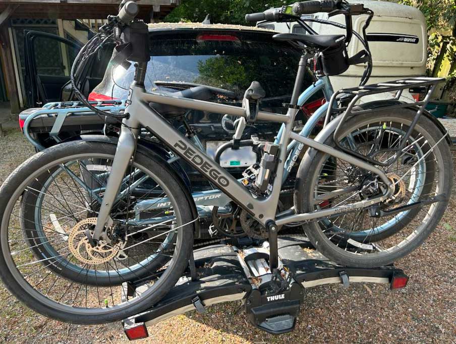 pedego electric bikes mounted on a car rack