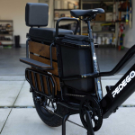 Pedego Cargo Ebike parked outside home with garage door open