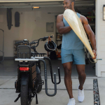 Surfer loads up board on Pedego cargo ebike